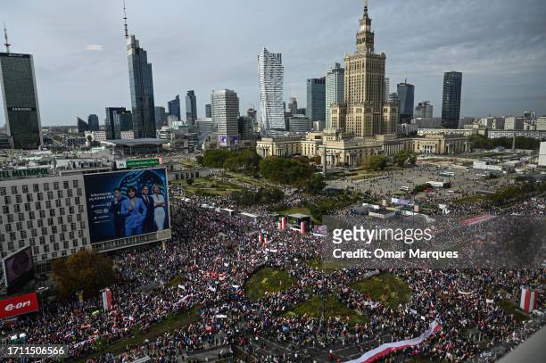 Thousands of people hold Polish and EU flags as Donald Tusk, the leader of Civic Coalition delivers a speech during the March of a million Hearts on...