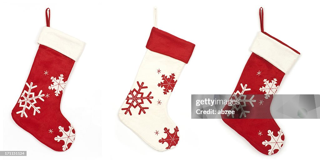 Thress Christmas stockings with shadow on white background