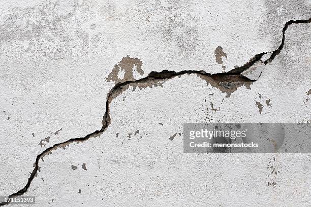 a big crack on an old, rotten wall - earthquake stock pictures, royalty-free photos & images