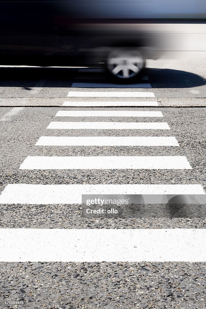 Crosswalk - road marking and speeding car