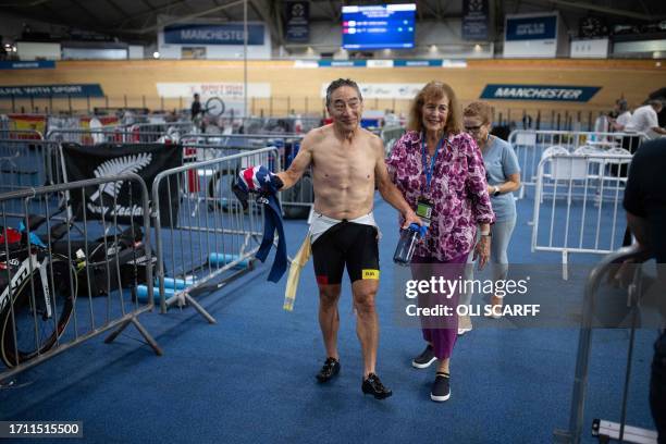 Kurt Sato , of the USA, reacts after receiving treatment for an injury sustained from a fall whilst competing against James Joseph, of Guyana, in the...