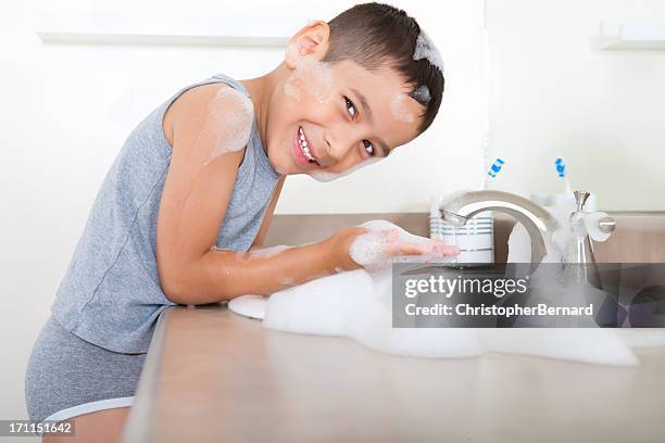 smiling boy washing hand - kids in undies stockfoto's en -beelden