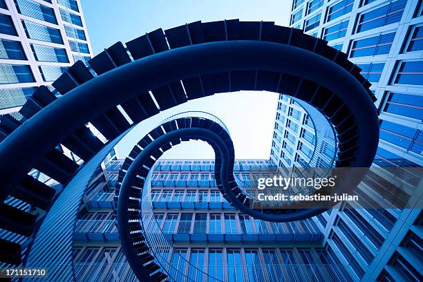 spiral stiars in front of modern architecture - panel gaming art or commerce stockfoto's en -beelden