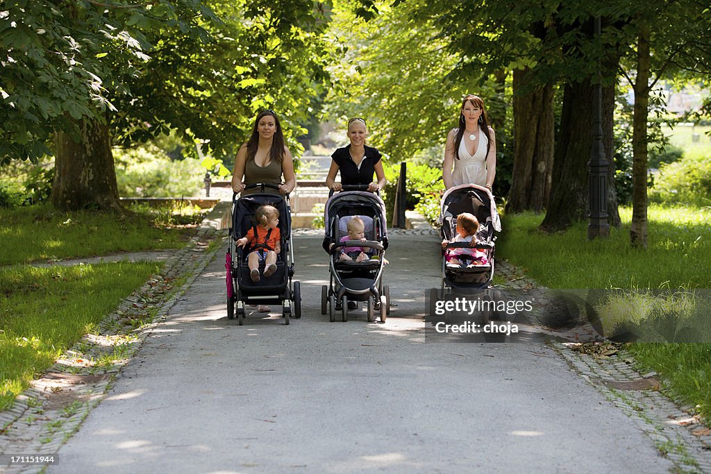 Young mothers in a park walking their babies