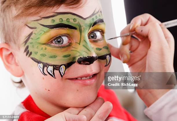 young boy with painted face - geschminkt gezicht stockfoto's en -beelden