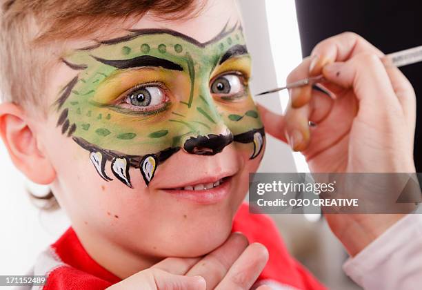 young boy with painted face - face painting stock pictures, royalty-free photos & images