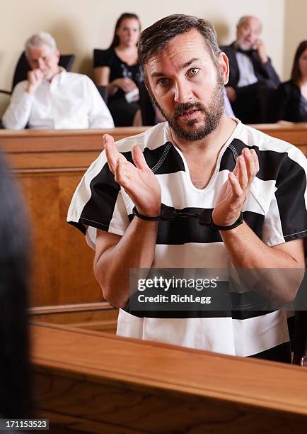 prisoner in court - handcuffed man standing in courtroom stock pictures, royalty-free photos & images