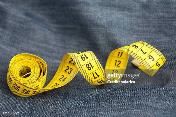 measure tape on jeans - centimetre stock pictures, royalty-free photos & images