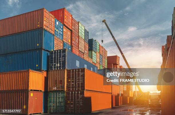 the container yard and dock, a symphony of industry and logistics. here, stacks of containers, like colorful building blocks, await their journey across the seas. cranes and machinery orchestrate the ballet of loading and unloading, ensuring the constant - containers harbour stock pictures, royalty-free photos & images