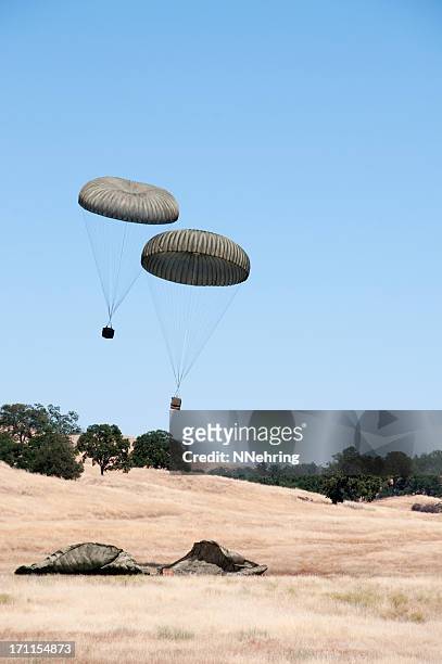 military air drop of four pallets - military crate stock pictures, royalty-free photos & images