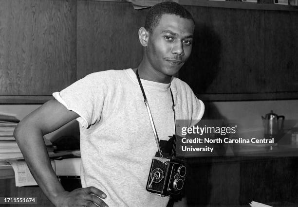 Photographer standing with camera at radio station in North Carolina.