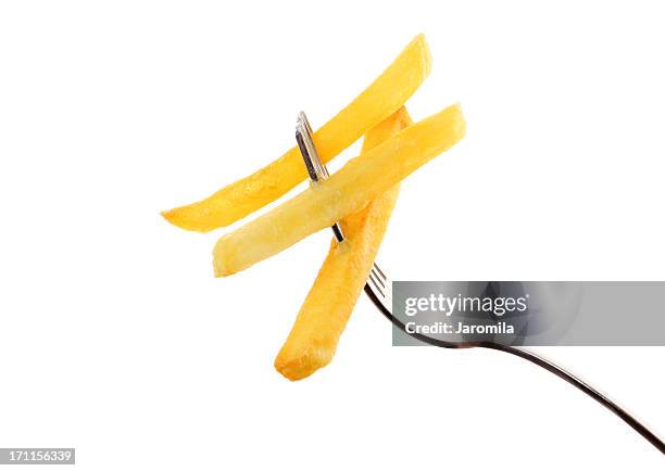 french fries on a fork - french fries isolated stock pictures, royalty-free photos & images