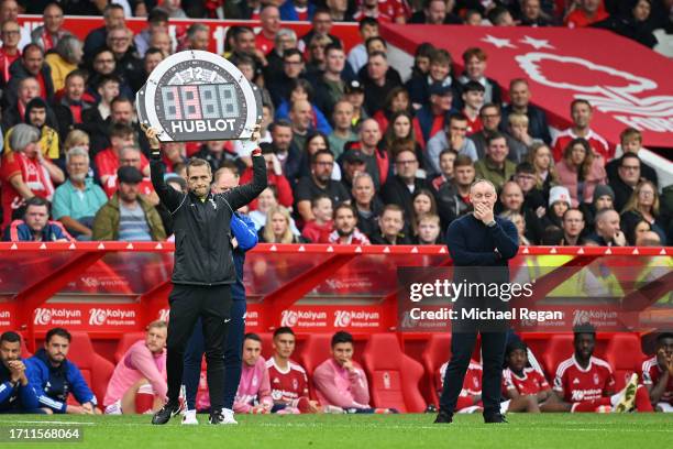 Fourth Official Craig Pawson holds up the extra time board which reads "13" minutes as Steve Cooper, Manager of Nottingham Forest, reacts during the...