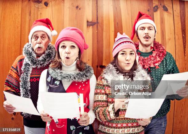 family singing christmas songs - carol singer stock pictures, royalty-free photos & images