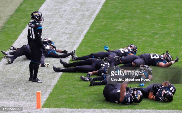 Darious Williams of the Jacksonville Jaguars celebrates with teammates after scoring a 61 yard touchdown, after an interception thrown by Desmond...