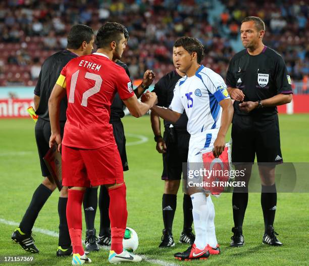 El Salvador's captain Rene Gomez shakes hands with Turkey's captain Ethem Pulgir during the group stage football match between Turkey and El Salvador...