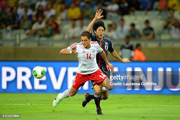 Javier Hernandez of Mexico draws the penalty against Atsuto Uchida of Japan during the FIFA Confederations Cup Brazil 2013 Group A match between...