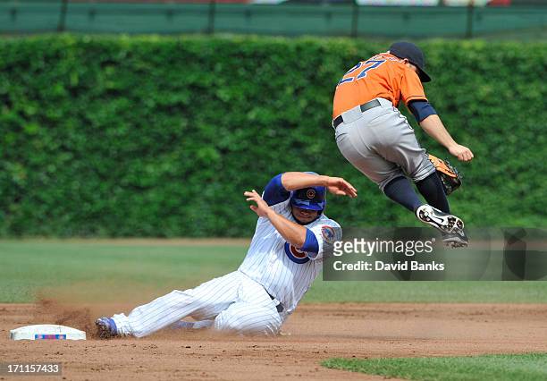 Welington Castillo of the Chicago Cubs is safe at second base on a fielders choice as Jose Altuve of the Houston Astros gets pulled off the base...