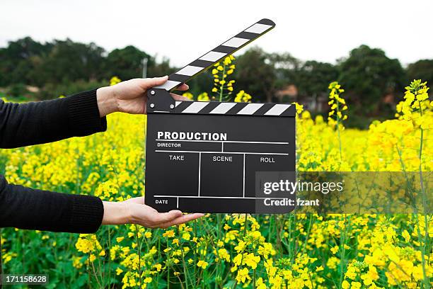 clapper board with hand - clapperboard stock pictures, royalty-free photos & images