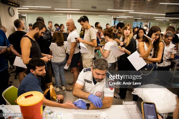 Israelis wait in line to donate blood in Tel Aviv's Sourasky Medical Center after officials call for people to donate blood on October 7, 2023 in Tel...