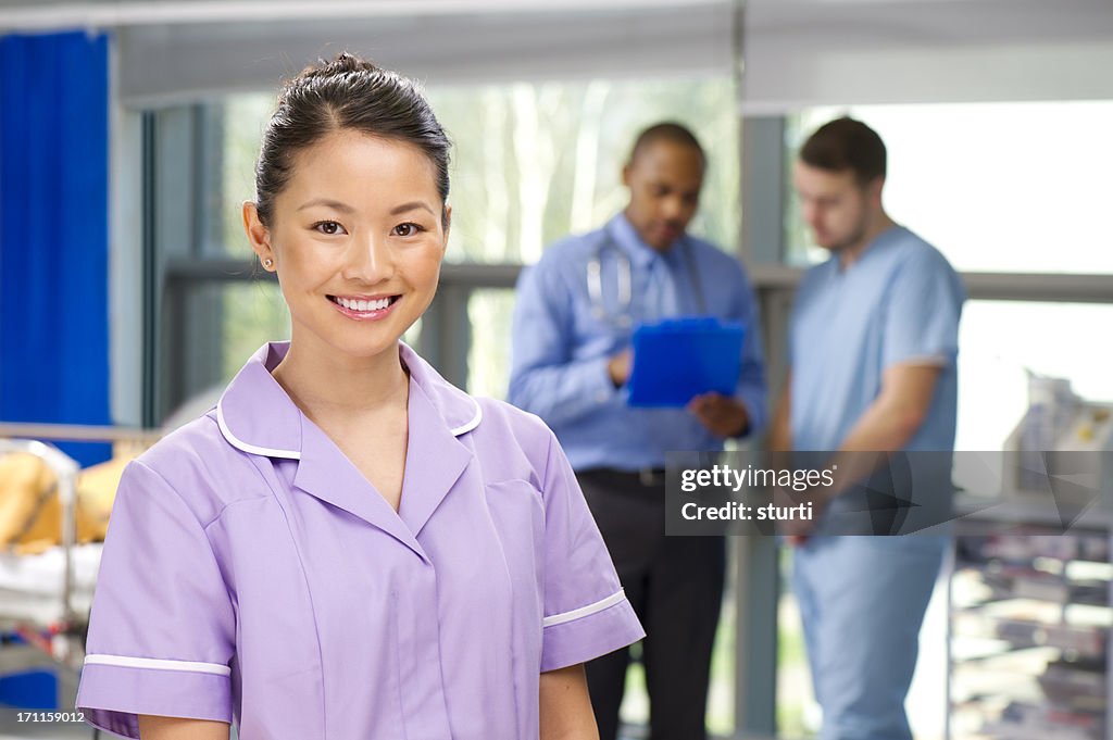 Happy nurse on a busy ward