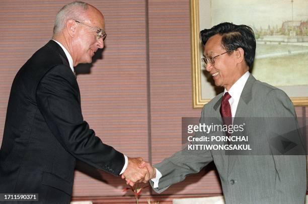 Roger C. Beach , Chief Executive Officer of Unocal, shakes hand with Thai Prime Minister Chuan Leekpai during courtesy call 28 April. Unocal...