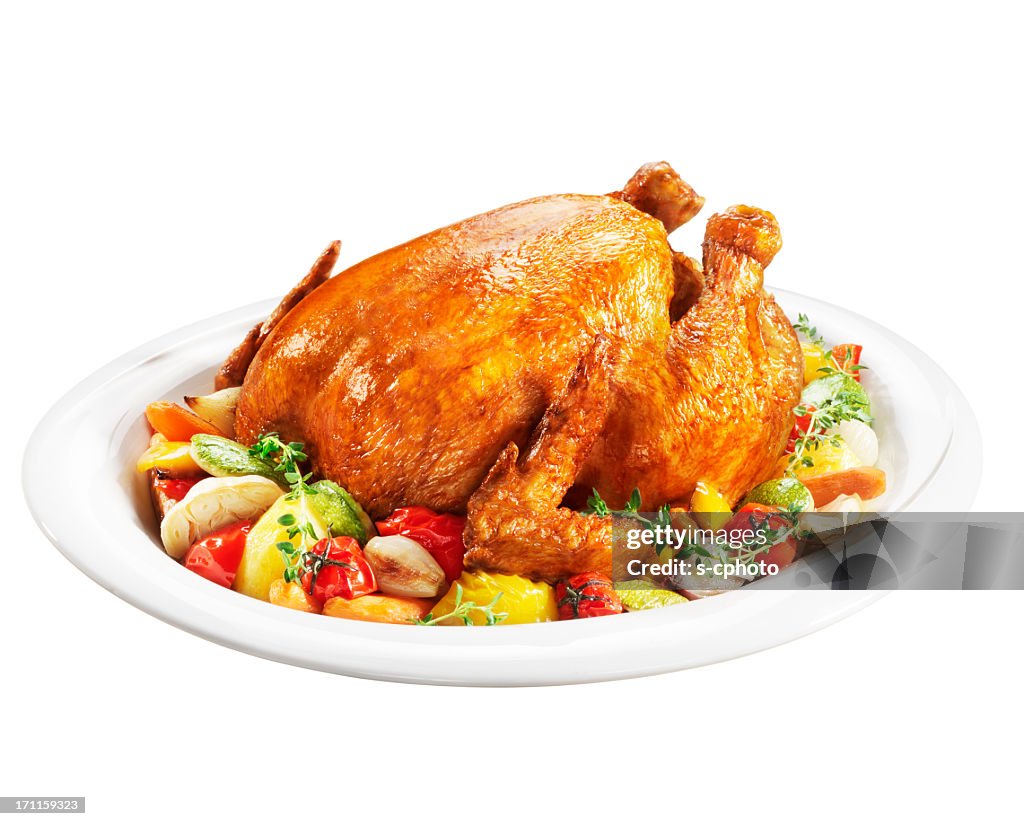Roast chicken on a plate of vegetables
