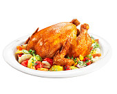 Roast chicken on a plate of vegetables
