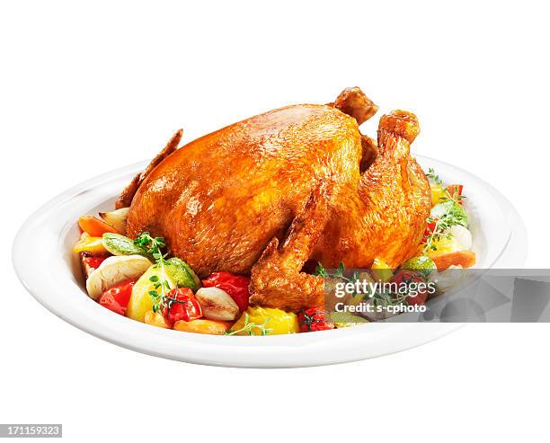 roast chicken on a plate of vegetables - roasted chicken stock pictures, royalty-free photos & images