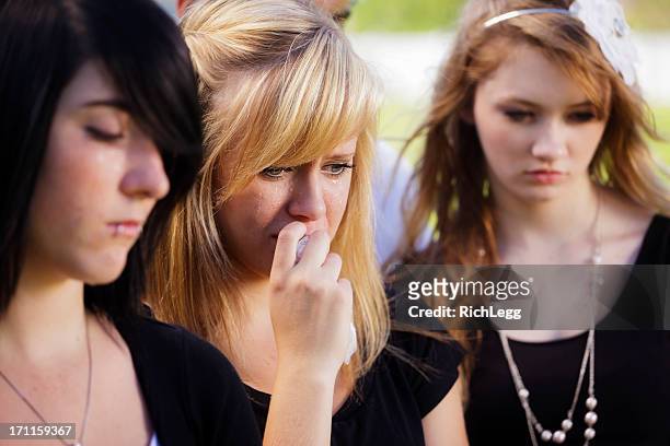 grieving teenage girl - mourner stock pictures, royalty-free photos & images