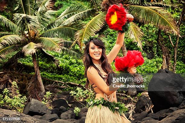 hawaiian hula dancer on beach with red feather shakers - hula dancing stock pictures, royalty-free photos & images