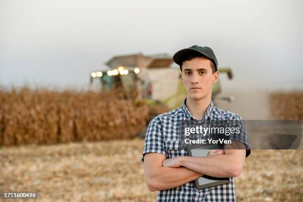 portrait of confident young farmer during corn harvest - may 19 stock pictures, royalty-free photos & images