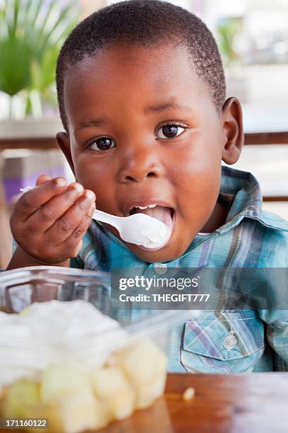 african child eating ice cream - child eating ice cream stock pictures, royalty-free photos & images