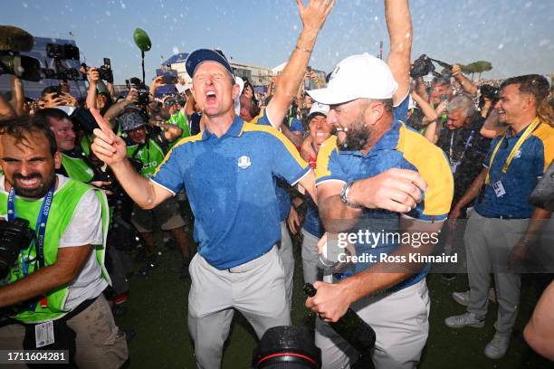 Justin Rose and Jon Rahm of Team Europe celebrate winning the Ryder Cup during the Sunday singles matches of the 2023 Ryder Cup at Marco Simone Golf...