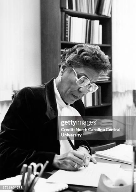 Librarian Annette Lewis Phinazee working in a university office.