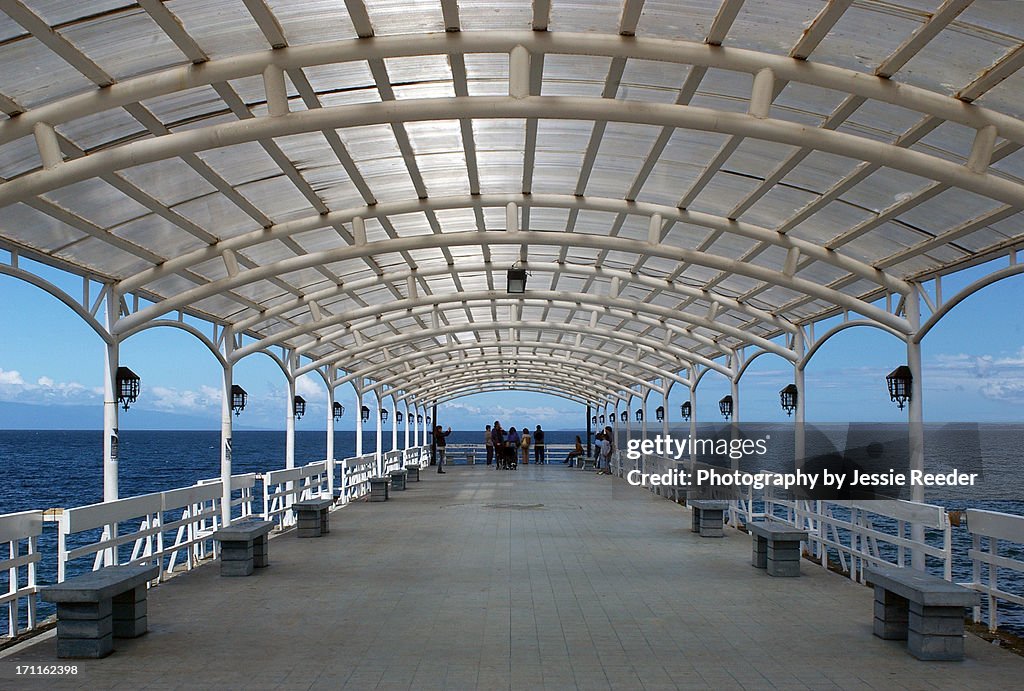 Symmetrical covered walkway by ocean