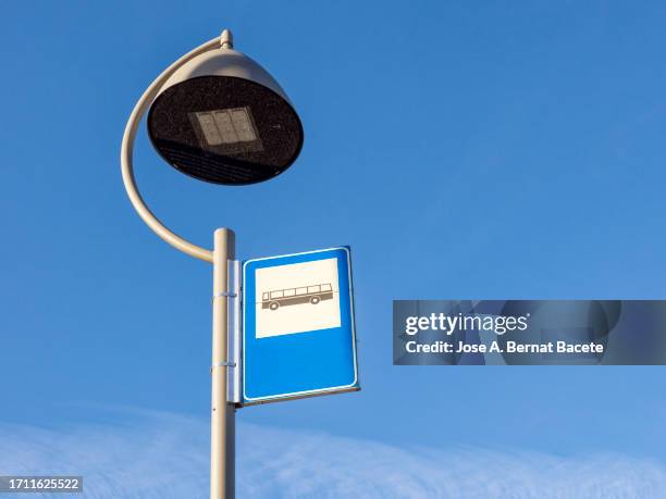 modern street lamp with led panel bulb and a bus stop plate. - bus stop imagens e fotografias de stock
