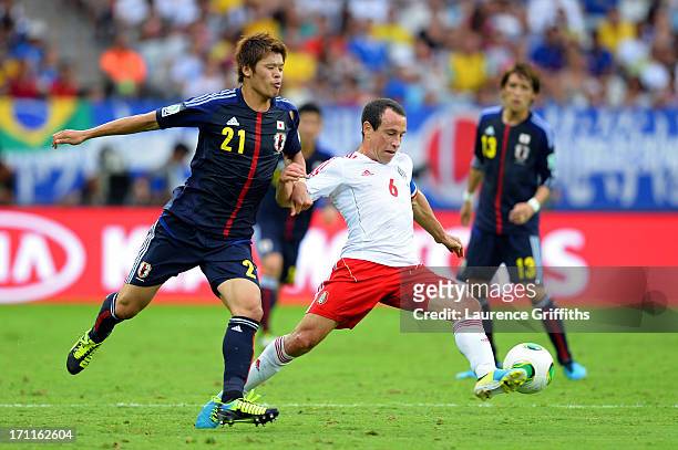 Gerardo Torrado of Mexico being marked by Hiroki Sakai of Japan during the FIFA Confederations Cup Brazil 2013 Group A match between Japan and Mexico...