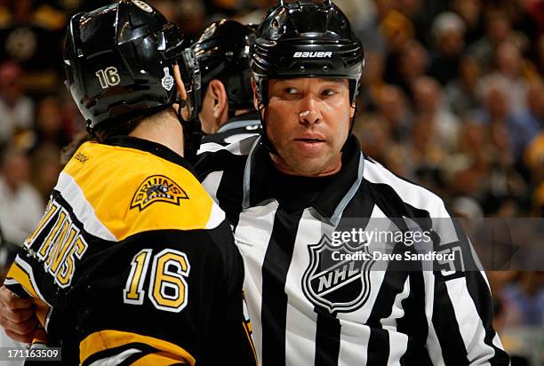 Linesman Jay Sharrers speaks with Kaspars Daugavins of the Boston Bruins during the third period of Game Four of the 2013 Stanley Cup Final at TD...