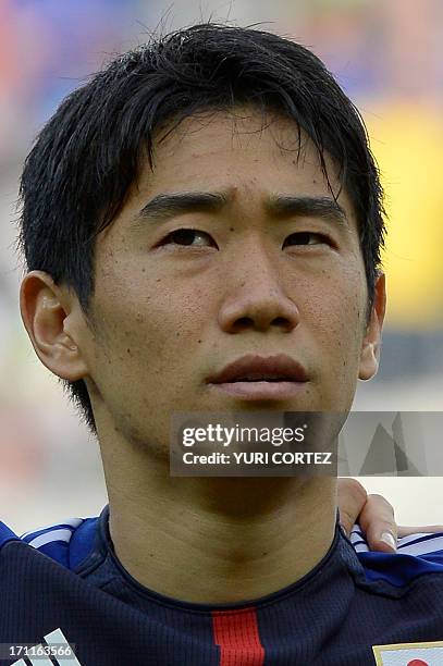 Japan's midfielder Shinji Kagawa listens to the national anthems before the start of the FIFA Confederations Cup Brazil 2013 Group A football match...