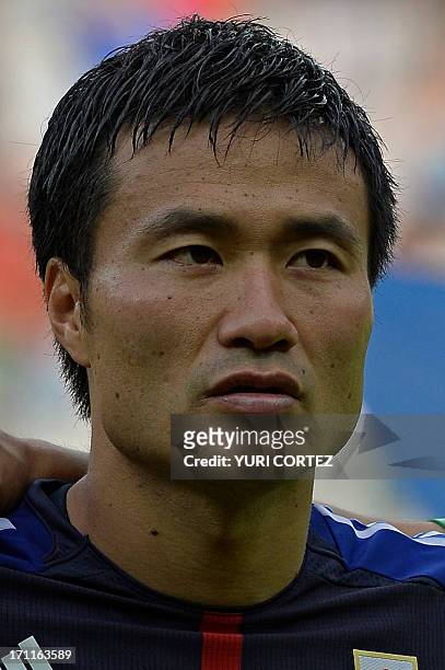 Japan's defender Yasuyuki Konno listens to the national anthems before the start of the FIFA Confederations Cup Brazil 2013 Group A football match...