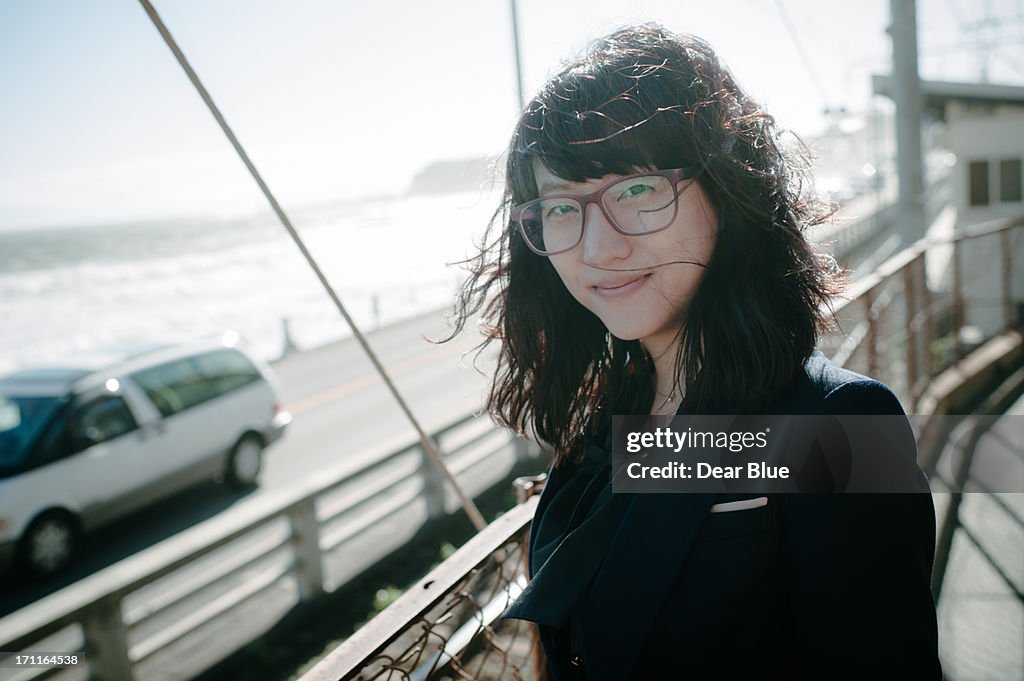 Korean girl with glasses smiles towards the camera
