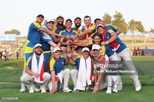 Luke Donald, Captain of Team Europe and players of Team Europe pose with the Ryder Cup trophy following victory with 16 and a half to 11 and a half...