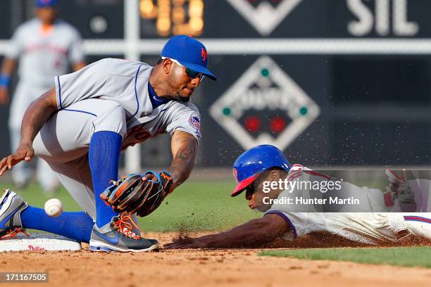 Ben Revere of the Philadelphia Phillies steals second base as Jordany Valdespin of the New York Mets drops the ball during a game at Citizens Bank...