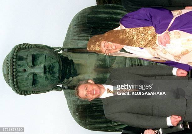 British Prime Minister Tony Blair listens to an explaination about the 11.5-meter-tall bronze made of great Buddha from 96-year-old Buddhist monk,...