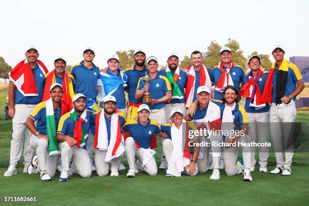 Luke Donald, Captain of Team Europe, Vice Captains and players of Team Europe pose with the Ryder Cup trophy following victory with 16 and a half to...