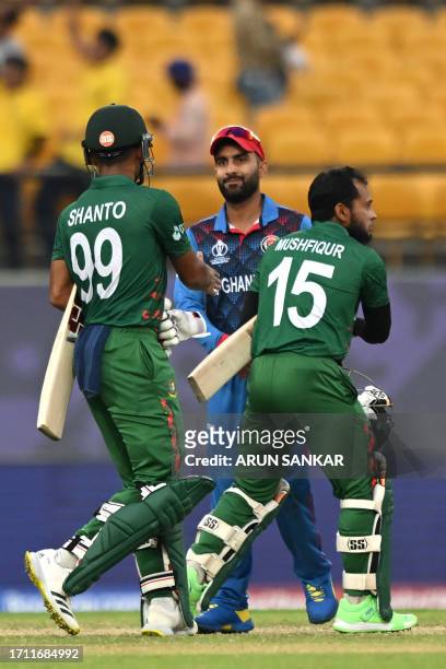 Afghanistan's captain Hashmatullah Shahidi greets Bangladesh's Najmul Hossain Shanto and Mushfiqur Rahim at the end of the 2023 ICC Men's Cricket...