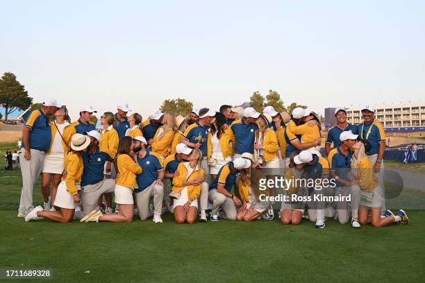 Luke Donald, Captain of Team Europe, players of Team Europe and their partners pose for a photograph with the Ryder Cup trophy following victory with...