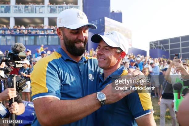 Rory McIlroy and Jon Rahm of Team Europe celebrate following victory with 16 and a half to 11 and a half win following the Sunday singles matches of...