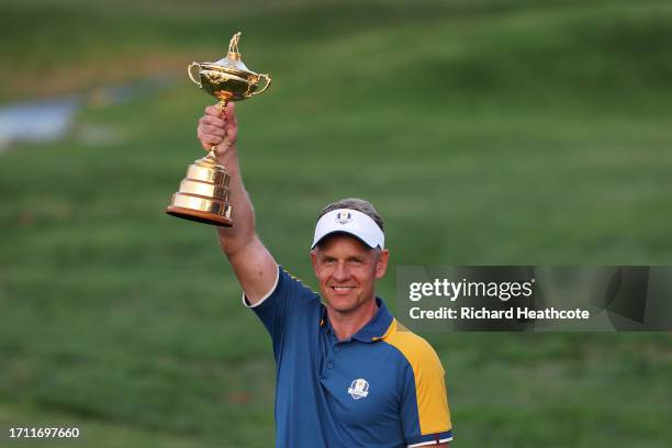 Luke Donald, Captain of Team Europe poses for a photograph with the Ryder Cup trophy following victory with 16 and a half to 11 and a half win during...
